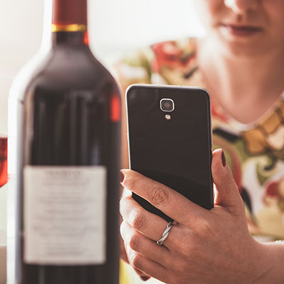 Woman using a wine app at the restaurant